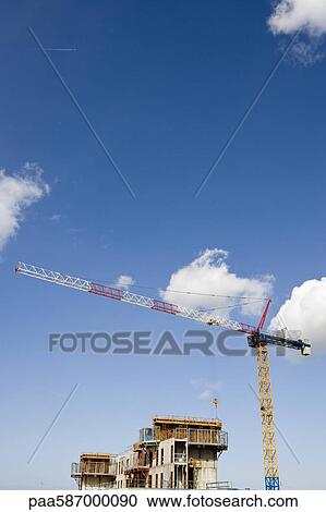 Stock Image - Crane and building under construction. Fotosearch