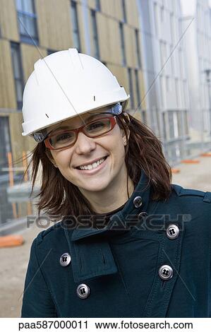 Stock Image - Female architect in hard hat, portrait. Fotosearch