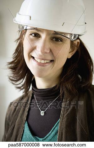 Stock Photo - Female architect in hard hat, portrait. Fotosearch