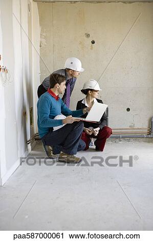 Property developer and business people using laptop at construction site View Large Photo Image Stock Image - Property developer and business people using laptop at construction site. Fotosearch