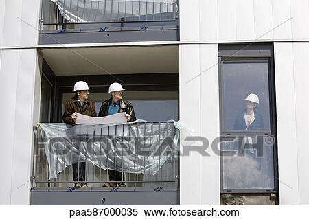 Property developer meeting with business people at building under construction View Large Photo Image Stock Photography - Property developer meeting with business people at building under construction. Fotosearch
