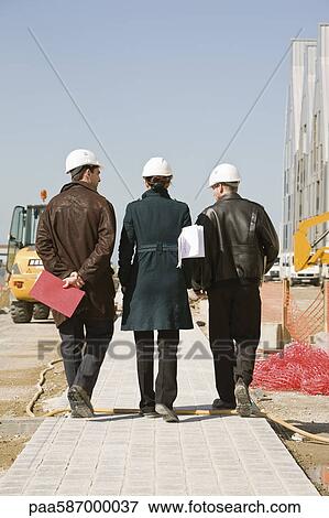Property developers walking at construction site, rear view View Large Photo Image Stock Photo - Property developers walking at construction site, rear view. Fotosearch