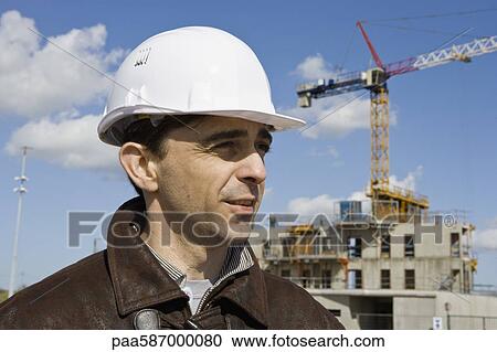 Stock Image - Site foreman in hard hat, portrait. Fotosearch