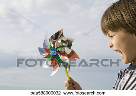 Boy playing with pinwheel View Large Photo Image Stock Image - Boy playing with pinwheel. Fotosearch