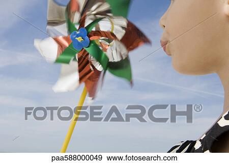 Child blowing pinwheel View Large Photo Image Stock Photo - Child blowing pinwheel. Fotosearch
