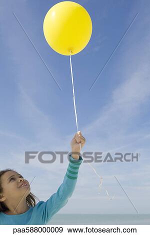 Girl holding balloon View Large Photo Image Stock Photo - Girl holding balloon. Fotosearch