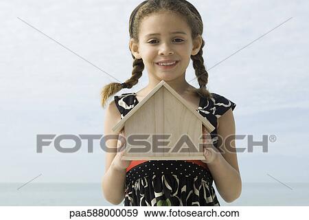 Girl holding birdhouse, portrait View Large Photo Image Stock Photo - Girl holding birdhouse, portrait. Fotosearch