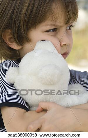 Little boy hugging teddy bear View Large Photo Image Stock Photo - Little boy hugging teddy bear. Fotosearch