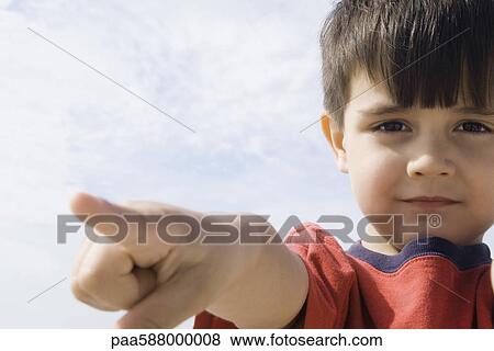 Little boy pointing, looking at camera View Large Photo Image Stock Photo - Little boy pointing, looking at camera. Fotosearch