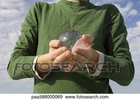 Person holding lightbulb in hands View Large Photo Image Stock Photo - Person holding lightbulb in hands. Fotosearch