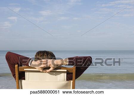 Stock Photography Of Person Relaxing In Chair On Beach Rear View Person Relaxing In Chair On Beach Rear View