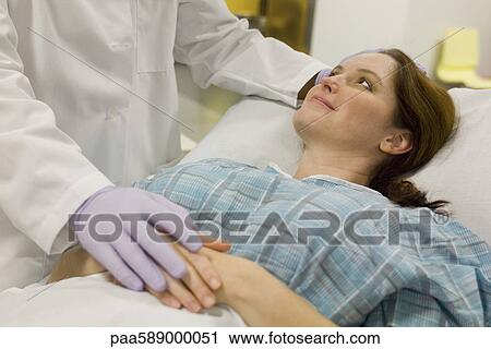 Doctor comforting female patient View Large Photo Image Stock Image - Doctor comforting female patient. Fotosearch