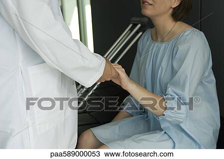Doctor comforting patient View Large Photo Image Stock Image - Doctor comforting patient. Fotosearch