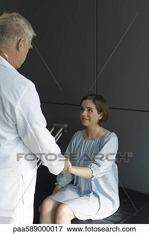 Doctor comforting patient View Large Photo Image Stock Photo - Doctor comforting patient. Fotosearch