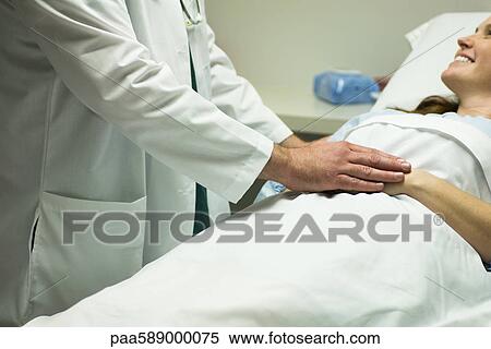 Doctor comforting patient View Large Photo Image Stock Photography - Doctor comforting patient. Fotosearch