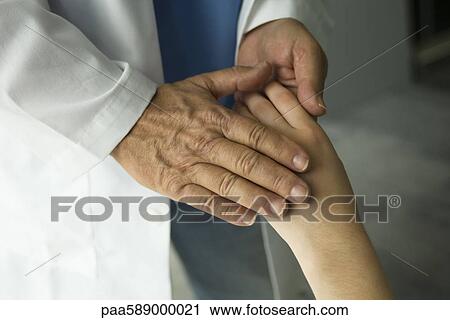 Doctor holding patient's hand View Large Photo Image Stock Image - Doctor holding patient's hand. Fotosearch