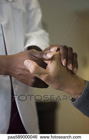 Doctor holding patient's hand View Large Photo Image Stock Photograph - Doctor holding patient's hand. Fotosearch