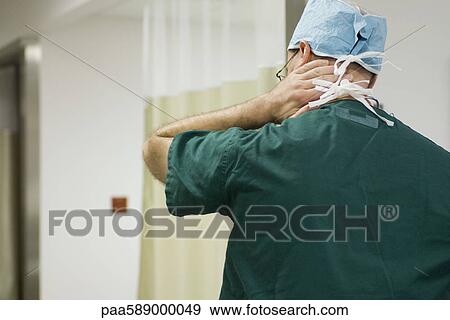 Doctor massaging neck, rear view View Large Photo Image Stock Photo - Doctor massaging neck, rear view. Fotosearch