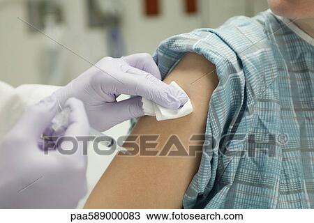 Doctor placing gauze on patient's arm after administering a shot View Large Photo Image Stock Image - Doctor placing gauze on patient's arm after administering a shot. Fotosearch