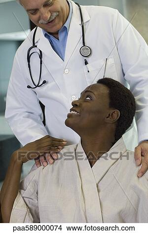 Picture - Doctor reassuring patient. Fotosearch