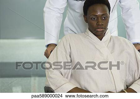 Female patient being pushed in wheelchair View Large Photo Image Picture - Female patient being pushed in wheelchair. Fotosearch