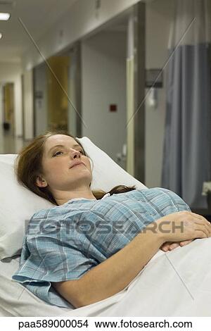 Female patient lying on hospital gurney View Large Photo Image Picture - Female patient lying on hospital gurney. Fotosearch