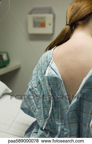 Female patient with examination gown open in back View Large Photo Image Stock Photo - Female patient with examination gown open in back. Fotosearch