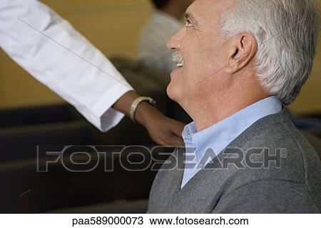 Healthcare worker reassuring man in waiting room View Large Photo Image Stock Image - Healthcare worker reassuring man in waiting room. Fotosearch