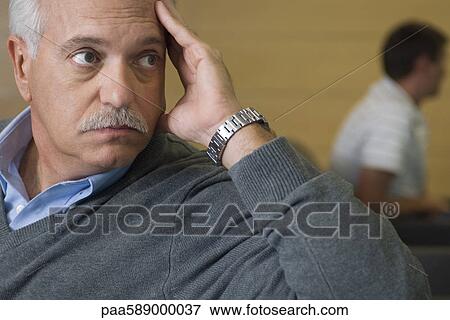 Mature man looking away with worry View Large Photo Image Stock Photo - Mature man looking away with worry. Fotosearch