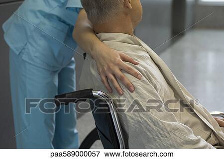 Nurse helping patient in wheelchair, cropped View Large Photo Image Stock Photo - Nurse helping patient in wheelchair, cropped. Fotosearch