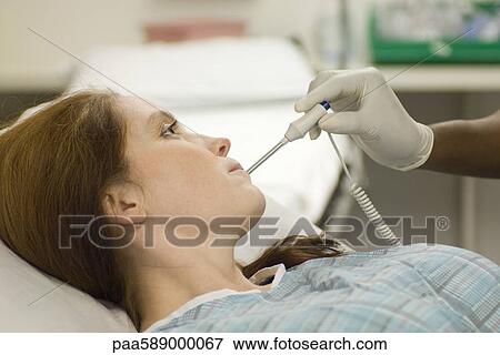 Nursing taking patient's temperature View Large Photo Image Stock Photo - Nursing taking patient's temperature. Fotosearch