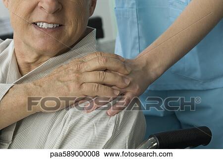 Stock Photo - Patient holding nurse's hand, cropped. Fotosearch