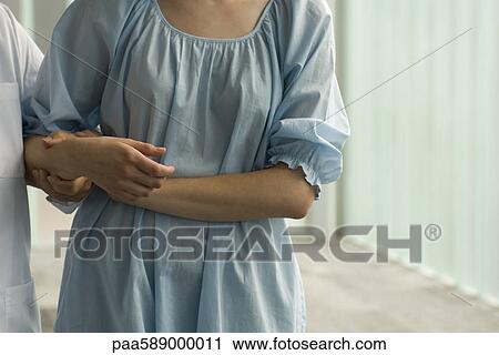 Patient holding on to nurse's arm for support View Large Photo Image Stock Image - Patient holding on to nurse's arm for support. Fotosearch