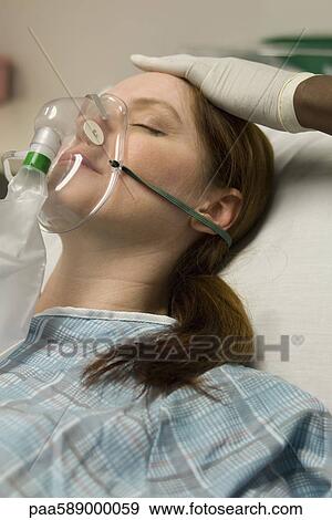 Patient receiving oxygen treatment View Large Photo Image Stock Photo - Patient receiving oxygen treatment. Fotosearch