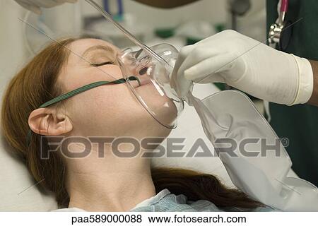 Patient receiving oxygen treatment View Large Photo Image Stock Photo - Patient receiving oxygen treatment. Fotosearch