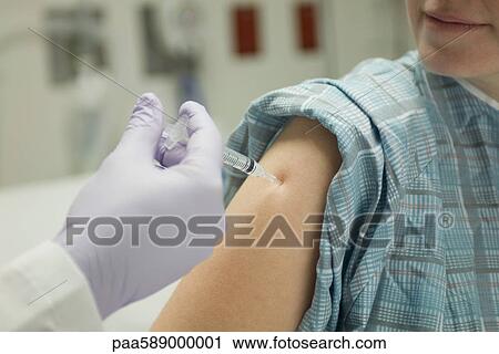Patient receiving shot in shoulder View Large Photo Image Stock Image - Patient receiving shot in shoulder. Fotosearch
