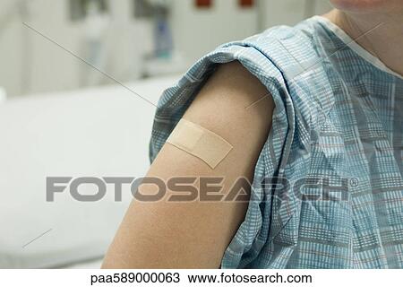 Patient with adhesive bandage on arm View Large Photo Image Stock Image - Patient with adhesive bandage on arm. Fotosearch