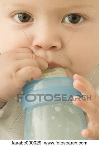 Stock Photo - baby, toddler, infant, drinking, baby bottle, baby bottles, face. Fotosearch