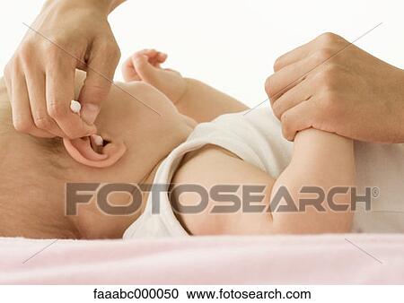 Stock Image - baby, toddler, infant, ear, ears, cleaning, infancy. Fotosearch