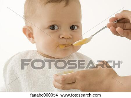 baby, toddler, infant, eating, feeding, baby food, bib View Large Photo Image Picture - baby, toddler, infant, eating, feeding, baby food, bib. Fotosearch