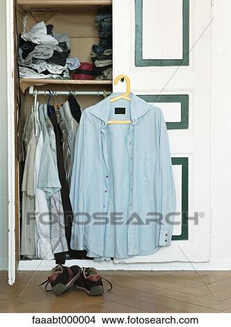 button down shirt, button down shirts, buttondown shirt, button-down shirt, hanger, hangers, closet View Large Photo Image Picture - button down shirt, button down shirts, buttondown shirt, button-down shirt, hanger, hangers, closet. Fotosearch