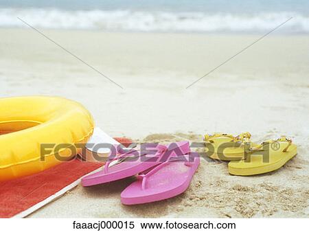 Stock Photography - flipflop, flipflops, beach, sand, inflatable ring. Fotosearch