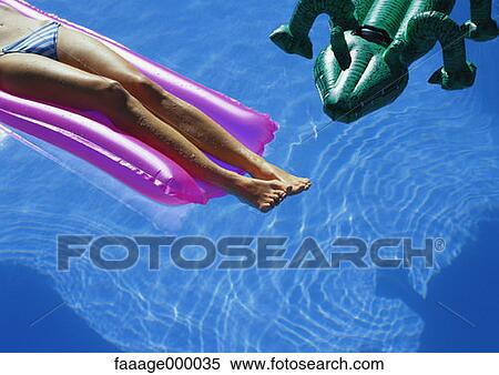 Stock Photography - leg, woman, females, water, sun, sunshine, tanning. Fotosearch