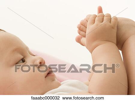 Stock Image - looking, baby, toddler, infant, foot, feet, only one baby. Fotosearch