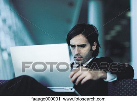 Stock Image - male, males, computer, computers, concentrated, businessman. Fotosearch