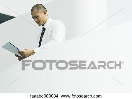 Picture - reading, male, males, executive, executives, businessman. Fotosearch