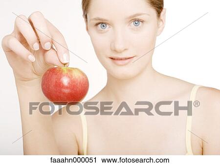 Stock Image - woman, females, food, apple, seductress, holding, tempting. Fotosearch
