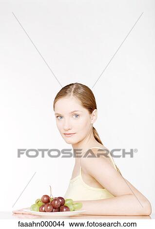 Picture - woman, females, food, grape, grapes, natural, food and drink. Fotosearch