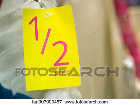1/2 price tag on clothing, close-up View Large Photo Image Stock Photo - 1/2 price tag on clothing, close-up. Fotosearch