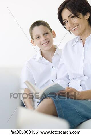 Boy and mature woman with book, smiling at camera View Large Photo Image Stock Photography - Boy and mature woman with book, smiling at camera. Fotosearch